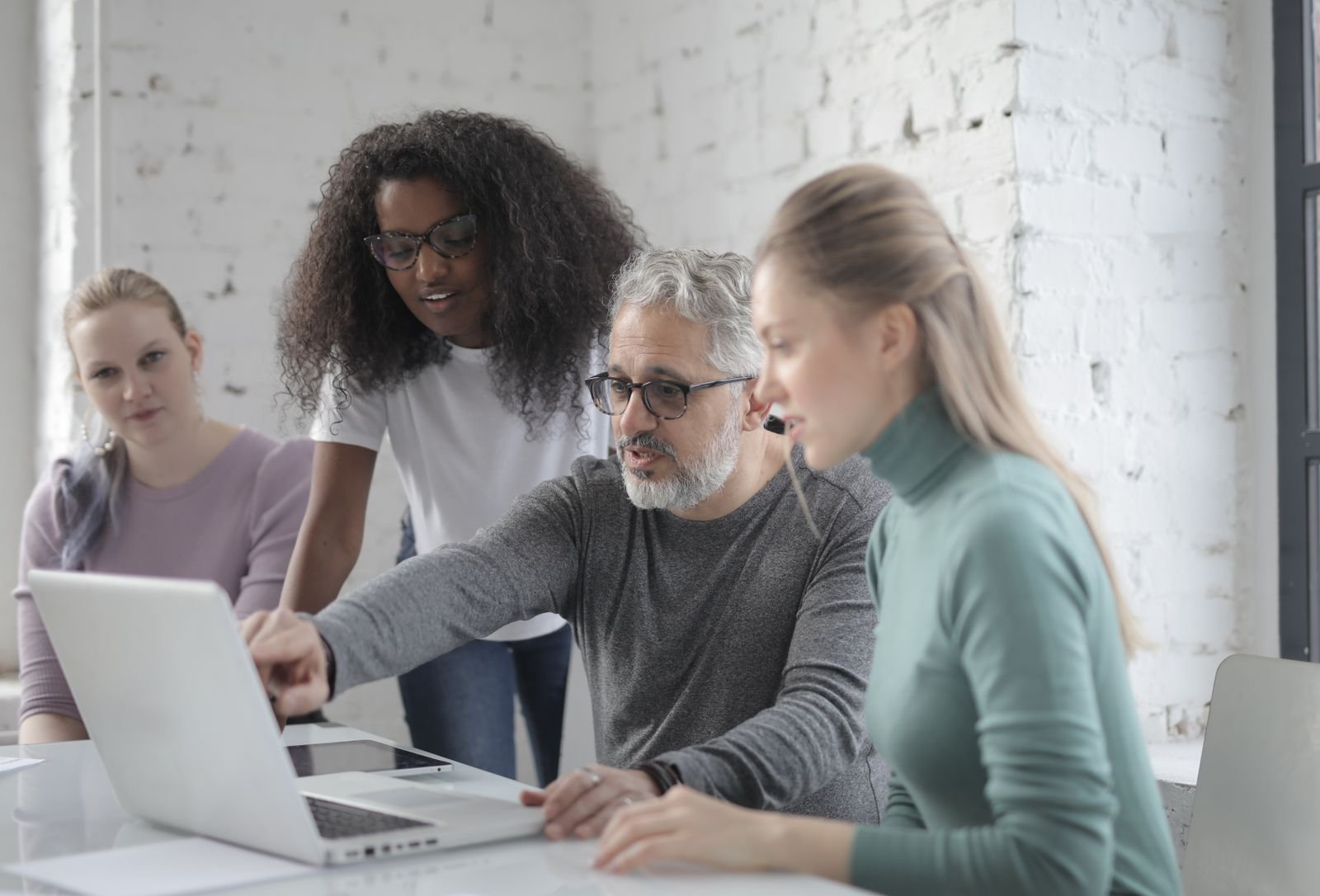 Team reviewing a website project together on a laptop